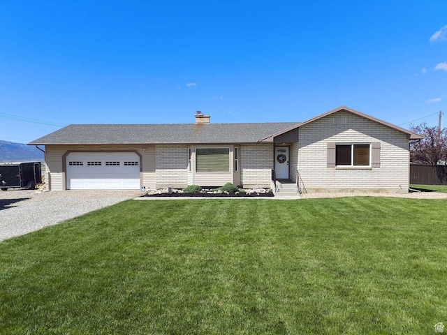 410 E 500 N, Ephraim, UT 84627 - ranch-style home featuring a front lawn, a chimney, entry steps, an attached garage, and gravel driveway