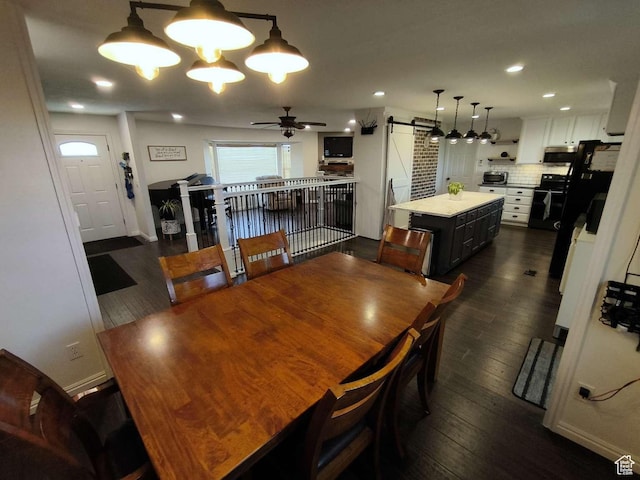 410 E 500 N, Ephraim, UT 84627 - dining space featuring dark wood finished floors, a barn door, baseboards, and ceiling fan