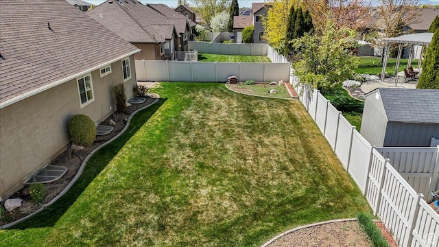 view of yard with a fenced backyard, a gazebo, and a residential view