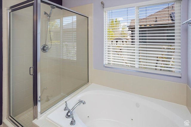 full bathroom with a shower stall and a tub with jets