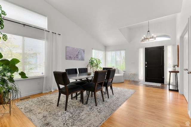 1962 E Meadow Downs Way S, Cottonwood Heights, UT 84121 - dining area featuring high vaulted ceiling, light wood-type flooring, an inviting chandelier, baseboards, and visible vents