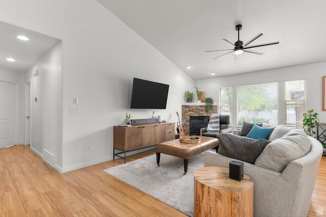 1962 E Meadow Downs Way S, Cottonwood Heights, UT 84121 - living room with lofted ceiling, visible vents, a ceiling fan, a fireplace, and light wood-style flooring