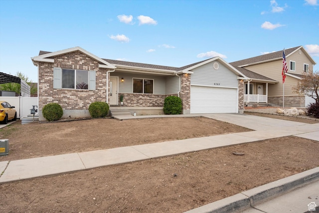 view of front of property featuring a garage, brick siding, concrete driveway, and covered porch