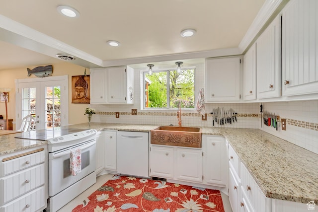 982 E 315 S, Orem, UT 84097 - kitchen featuring a peninsula, a healthy amount of sunlight, a sink, and white appliances