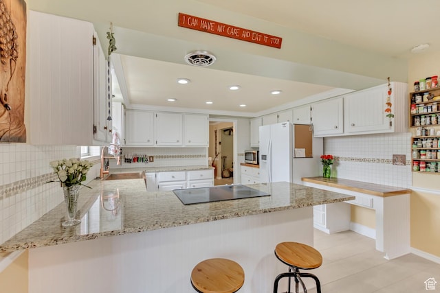 982 E 315 S, Orem, UT 84097 - kitchen featuring a peninsula, stovetop, white fridge with ice dispenser, and backsplash