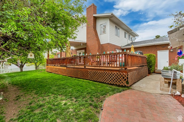 982 E 315 S, Orem, UT 84097 - rear view of house featuring a chimney, a patio area, a lawn, brick siding, and a deck