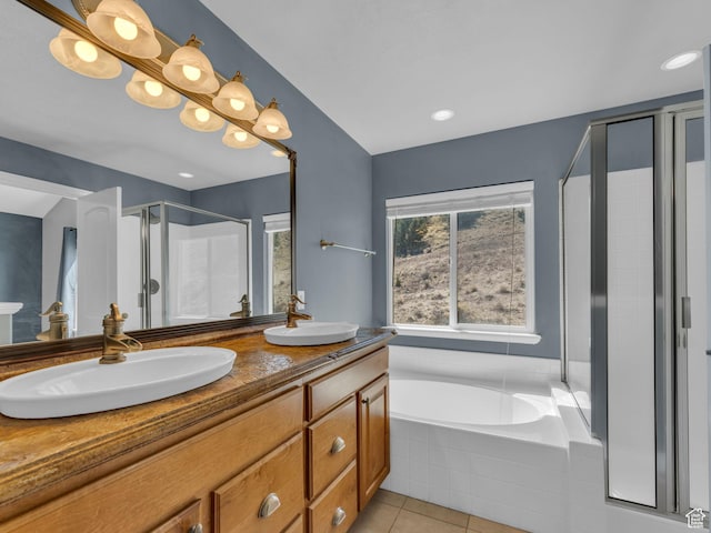 full bath featuring a shower stall, tile patterned floors, double vanity, and a garden tub
