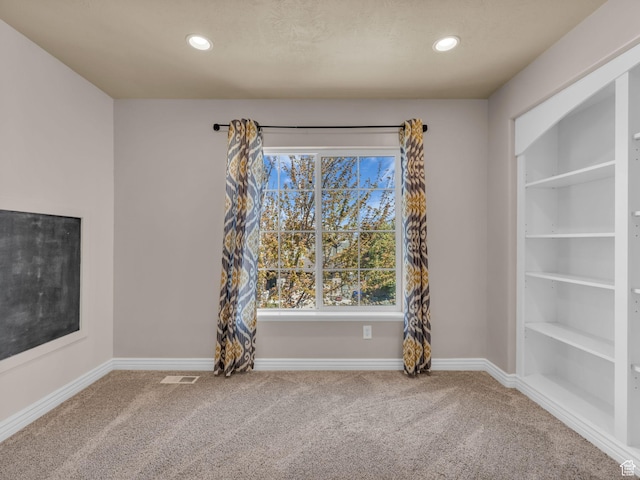 unfurnished dining area with carpet floors, baseboards, and recessed lighting