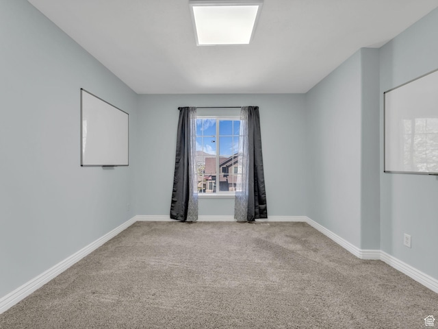 carpeted spare room with baseboards