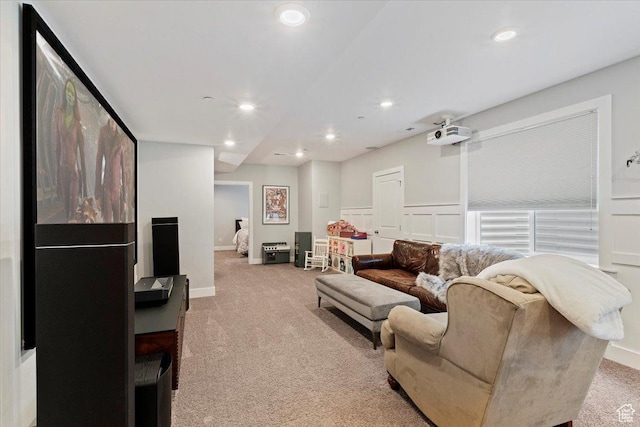 living room featuring light colored carpet, recessed lighting, and baseboards