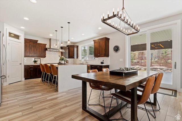 dining area featuring light wood-style flooring and recessed lighting