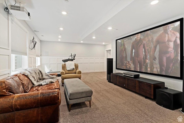 carpeted cinema room featuring recessed lighting, a wainscoted wall, and a decorative wall