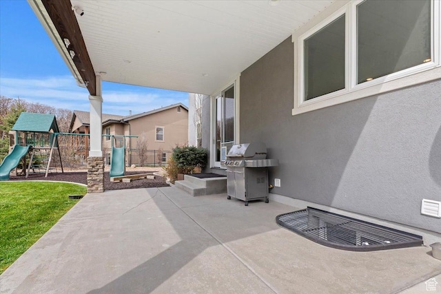 view of patio / terrace with a playground and a grill