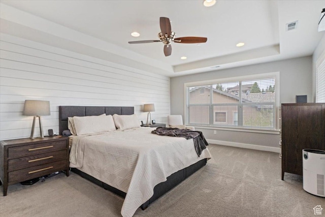 carpeted bedroom with recessed lighting, a raised ceiling, baseboards, and ceiling fan
