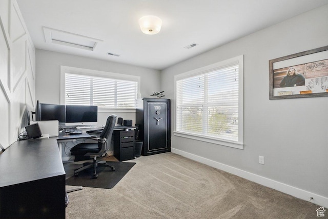 home office with baseboards, light colored carpet, and attic access