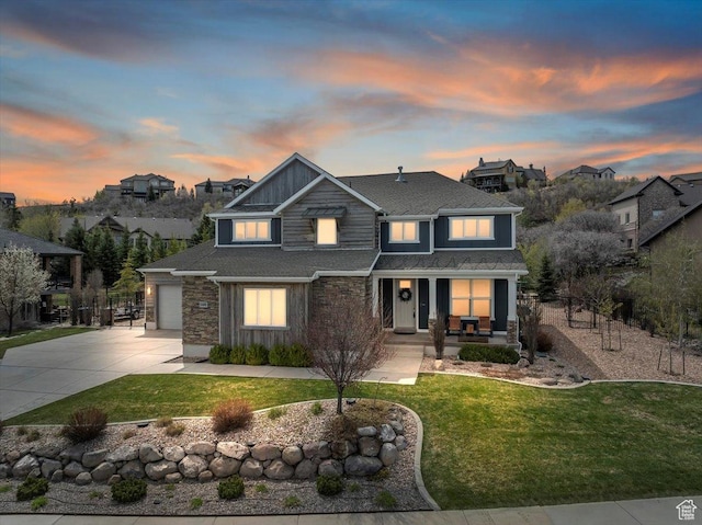 craftsman-style home with driveway, covered porch, stone siding, roof with shingles, and an attached garage