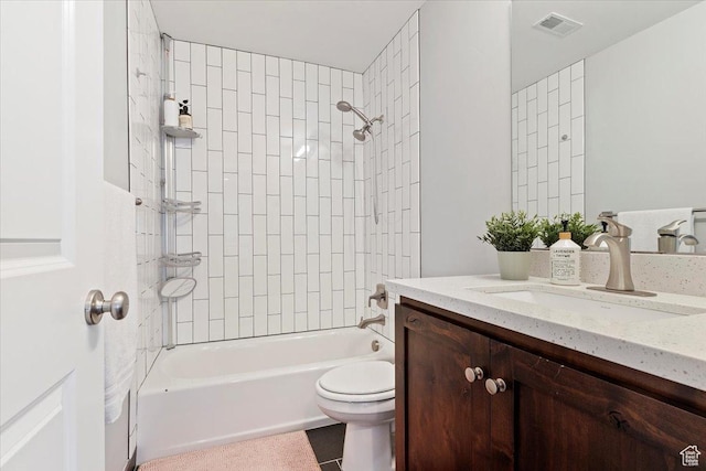 full bath featuring toilet, washtub / shower combination, vanity, and tile patterned floors