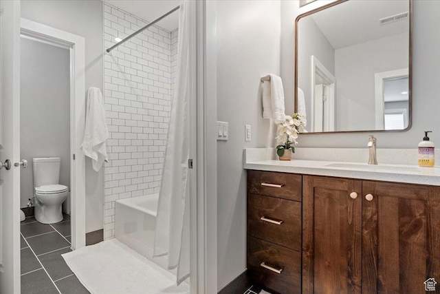 bathroom featuring tile patterned flooring, vanity, toilet, and shower / bathtub combination with curtain