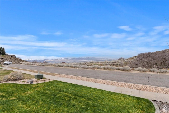 view of asphalt road with a mountain view