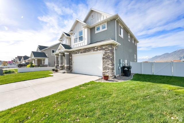 2385 E 430 S, Spanish Fork, UT 84660 - craftsman house featuring concrete driveway, stone siding, an attached garage, fence, and a front yard