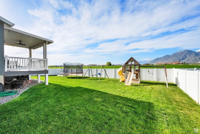 2385 E 430 S, Spanish Fork, UT 84660 - view of yard featuring a deck with mountain view, a fenced backyard, a playground, a trampoline, and ceiling fan