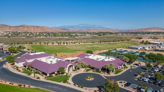 drone / aerial view with view of golf course and a mountain view