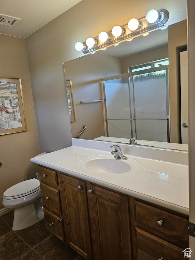 bathroom with tile patterned floors, toilet, visible vents, a shower stall, and vanity