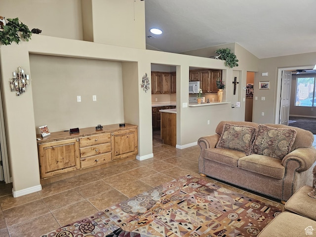 living room with high vaulted ceiling, baseboards, tile patterned floors, and recessed lighting