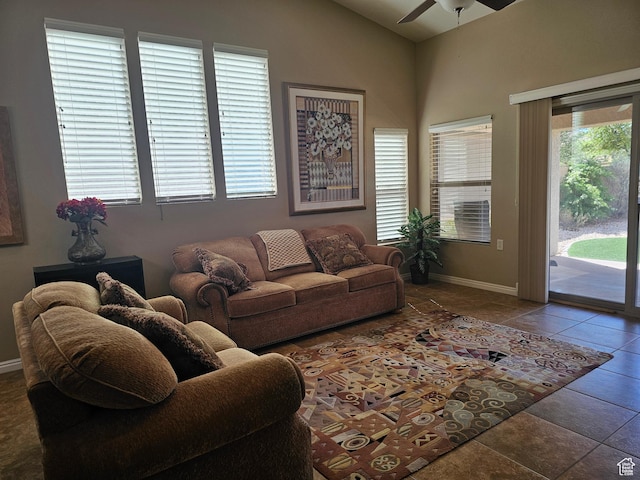 tiled living area with vaulted ceiling, baseboards, and ceiling fan