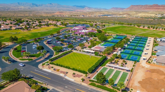 birds eye view of property with golf course view and a mountain view