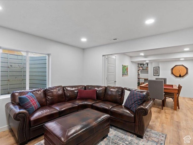 living room with recessed lighting, light wood-style floors, and visible vents