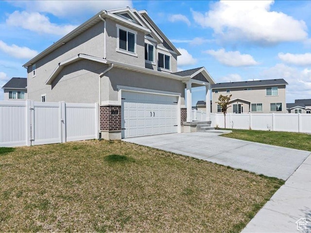 view of front of home featuring a gate, fence, a front lawn, concrete driveway, and an attached garage