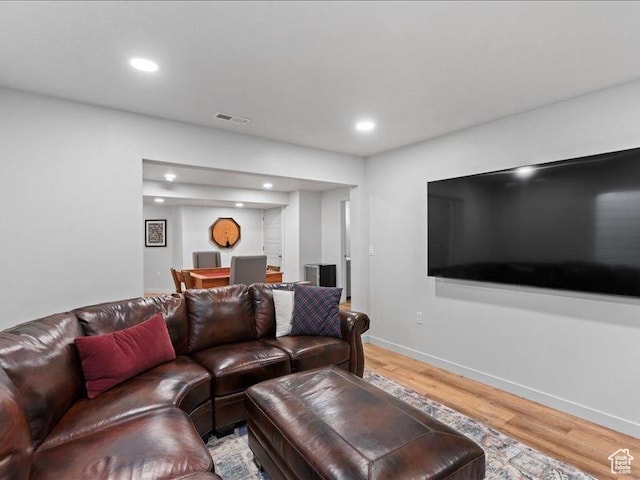 living area with baseboards, light wood finished floors, visible vents, and recessed lighting