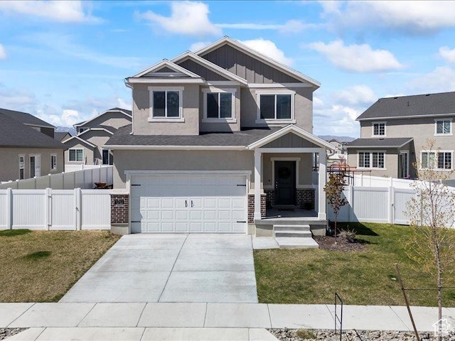 craftsman house featuring a front lawn, driveway, board and batten siding, and an attached garage