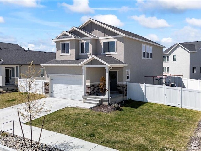 view of front of property with driveway, fence, a garage, board and batten siding, and a front yard