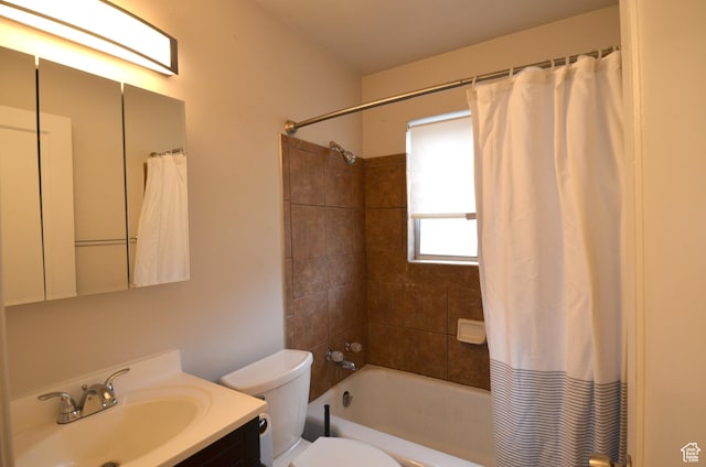 bathroom with shower / tub combo, toilet, and vanity