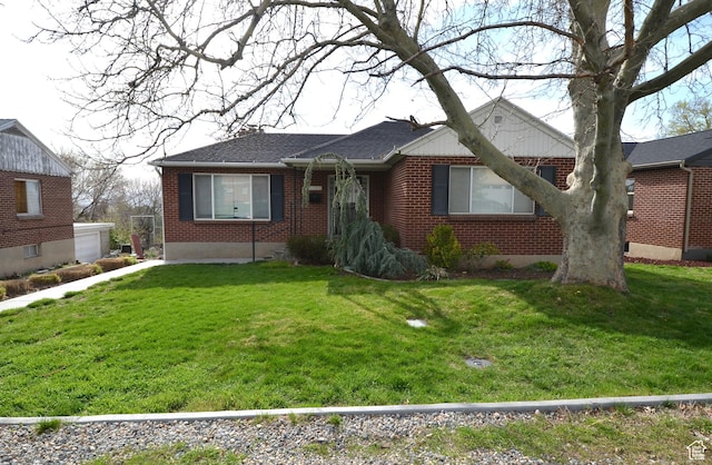 ranch-style house featuring brick siding and a front yard