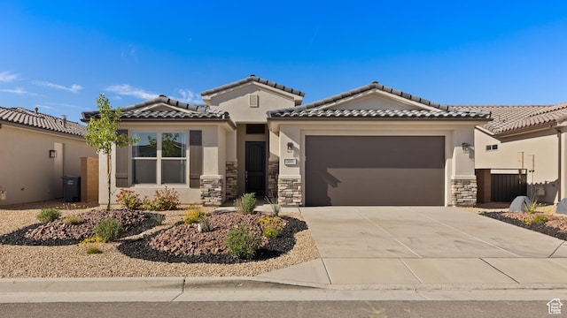 315 W Camino Borde, Washington, UT 84780 - view of front of house featuring a tile roof, driveway, stone siding, a garage, and stucco siding
