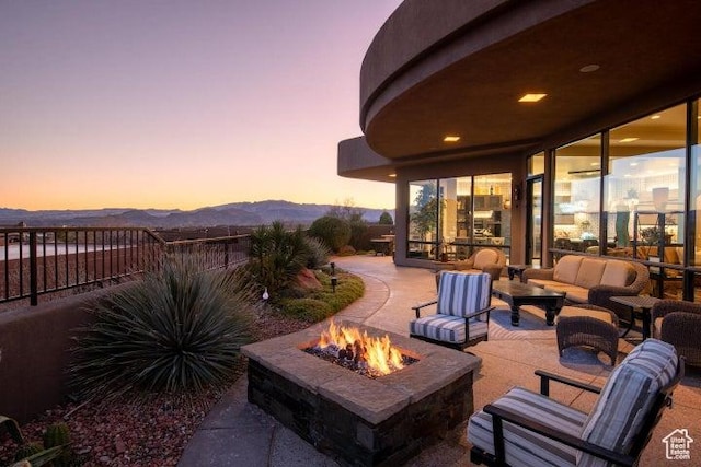 3052 N Snow Canyon Pkwy Unit 67, St George, UT 84770 - patio terrace at dusk with fence, an outdoor living space with a fire pit, and a mountain view