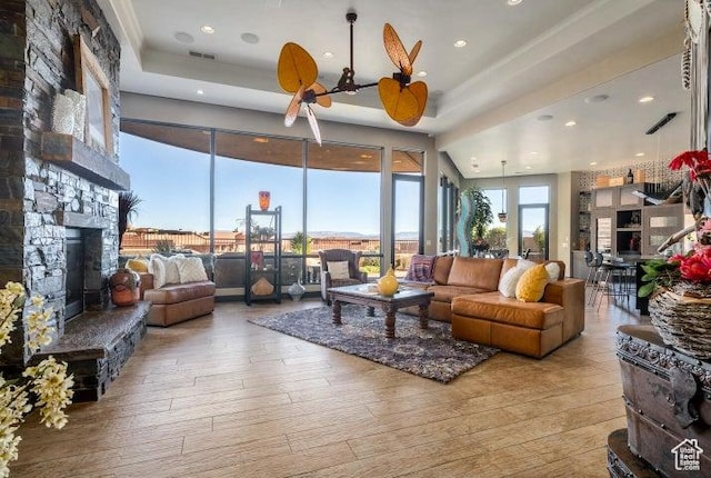 3052 N Snow Canyon Pkwy Unit 67, St George, UT 84770 - living room with hardwood / wood-style floors, a tray ceiling, a fireplace, visible vents, and recessed lighting