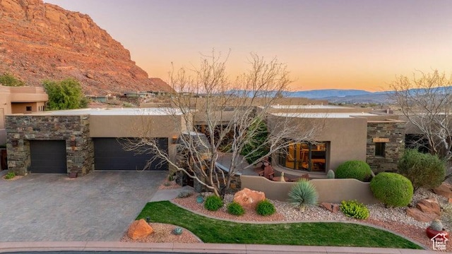 3052 N Snow Canyon Pkwy Unit 67, St George, UT 84770 - pueblo revival-style home with an attached garage, driveway, a mountain view, and stucco siding