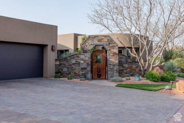 3052 N Snow Canyon Pkwy Unit 67, St George, UT 84770 - view of front of property featuring stucco siding, decorative driveway, and a garage
