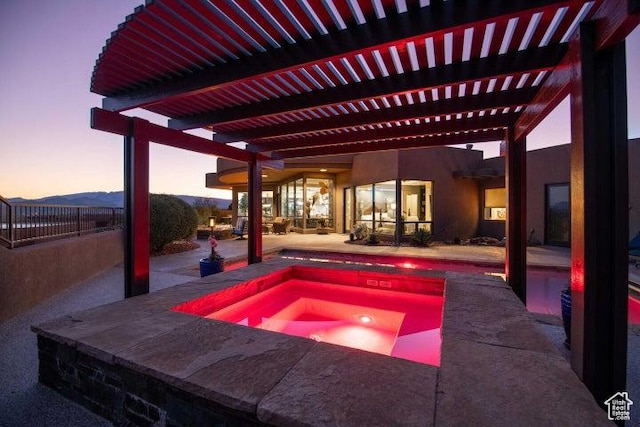 3052 N Snow Canyon Pkwy Unit 67, St George, UT 84770 - pool at dusk featuring a pool, a patio area, and an in ground hot tub