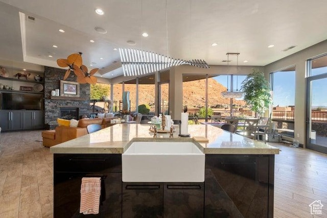 3052 N Snow Canyon Pkwy Unit 67, St George, UT 84770 - kitchen featuring hardwood / wood-style flooring, a stone fireplace, and recessed lighting