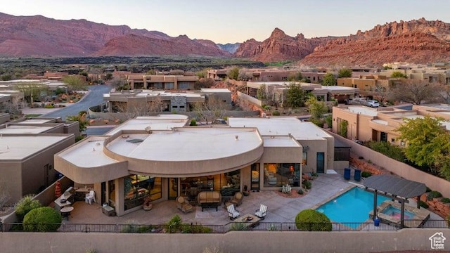 3052 N Snow Canyon Pkwy Unit 67, St George, UT 84770 - pool at dusk featuring a mountain view, fence, and a patio area