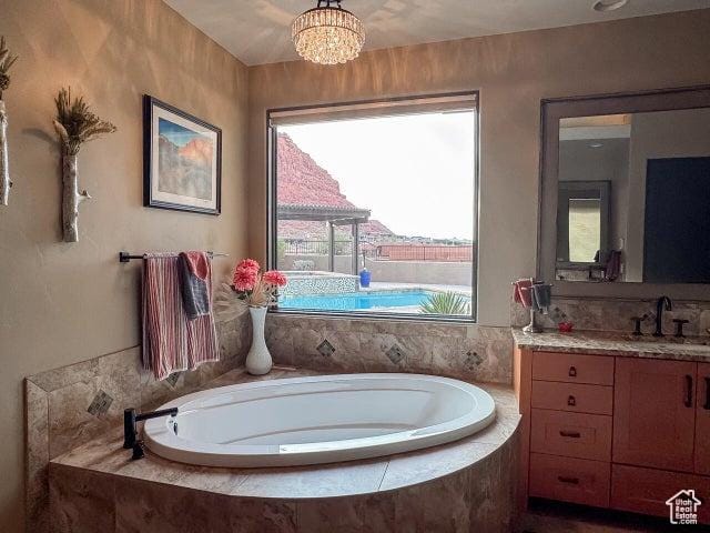 3052 N Snow Canyon Pkwy Unit 67, St George, UT 84770 - bathroom featuring a bath, a notable chandelier, and vanity
