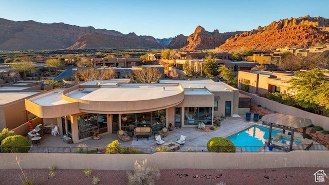 3052 N Snow Canyon Pkwy Unit 67, St George, UT 84770 - back of house with a fenced backyard, a mountain view, and a patio area