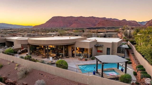 3052 N Snow Canyon Pkwy Unit 67, St George, UT 84770 - rear view of property with fence, stucco siding, a mountain view, and a patio