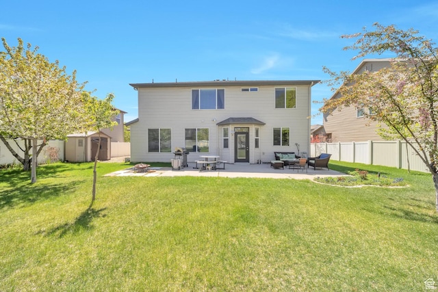 rear view of house with a yard, a storage unit, an outdoor structure, an outdoor hangout area, and a patio