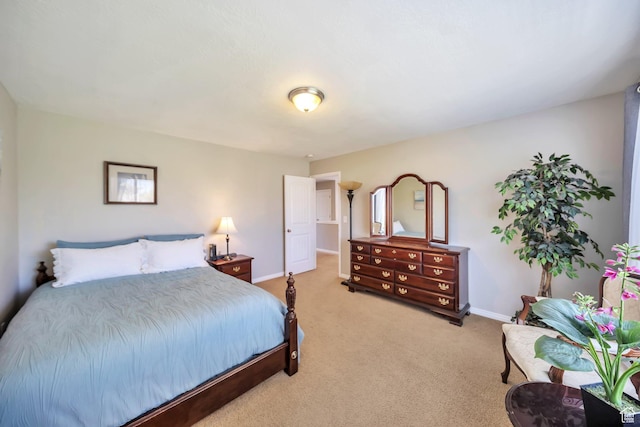 bedroom featuring light carpet and baseboards